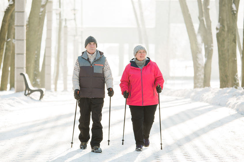 senior couple walking in the snow